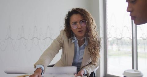 Architect collaborating on blueprints in modern office