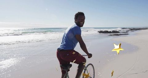 Man enjoying coastal bicycle ride on sunny beach