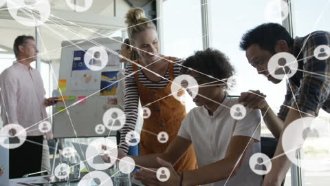 Diverse Team Networking Over Laptop in Office Setting