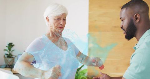 Senior woman lifting dumbbells with trainer guidance and anatomical ribcage overlay