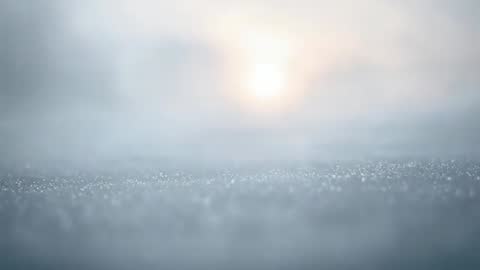 Glinting frost crystals sparkling at dawn across tranquil snowy field