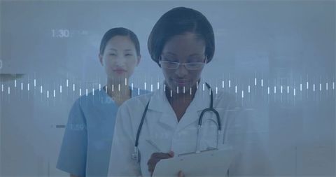 African American Physician Writing Clinical Notes with Asian Nurse and Waveform Overlay