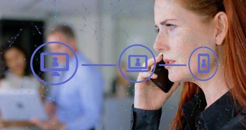 Red-haired professional holding smartphone and managing networked team collaboration