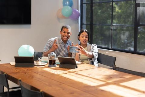 Cheerful Coworkers Capture Team Spirit at Workwith Smartphone