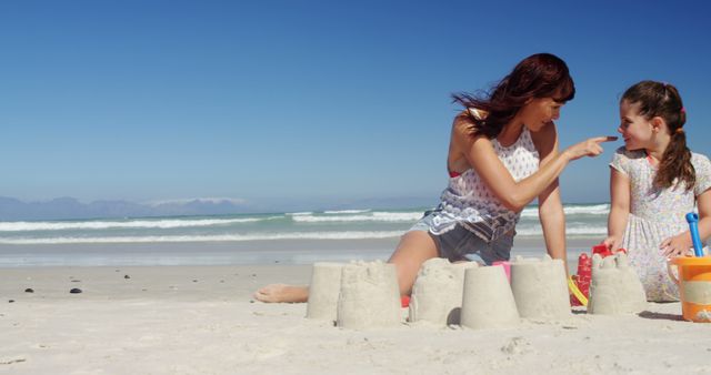 Mother and Daughter Building Sandcastles at Beach - Download Free Stock Images Pikwizard.com