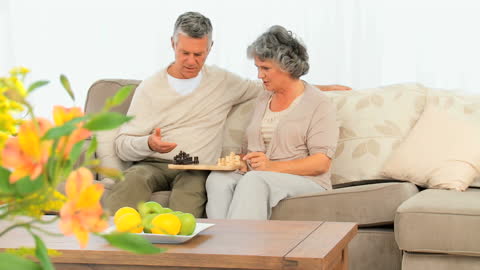 Senior Couple Enjoying a Relaxing Chess Game at Home