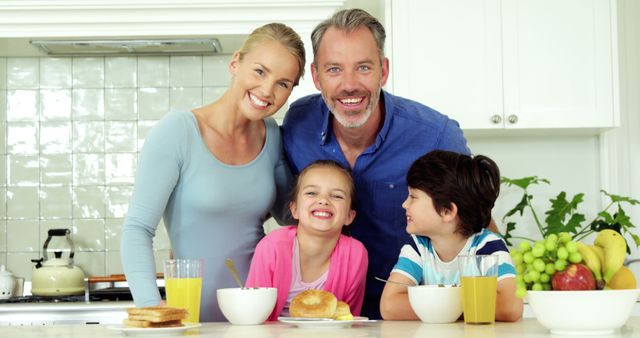 Happy Family of Four Enjoying Breakfast Together in Bright Kitchen - Download Free Stock Images Pikwizard.com