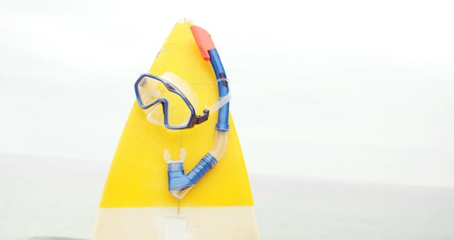 Snorkel and Mask Hanging on Yellow Sign at Beach - Download Free Stock Images Pikwizard.com
