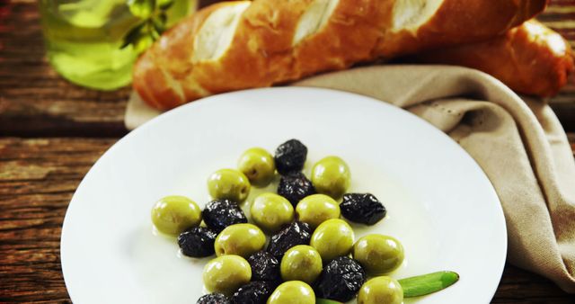 Assorted Olives on White Plate with Baguette in Background - Download Free Stock Images Pikwizard.com