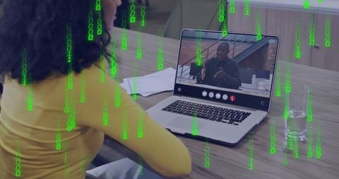 Woman Joining Remote Video Meeting on Laptop with Green Binary Overlay Representing Cybersecurity