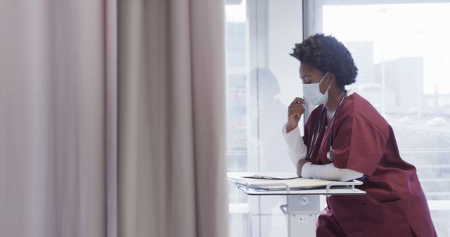 Pensive Female Doctor in Scrubs and Face Mask at Hospital Ward - Download Free Stock Images Pikwizard.com