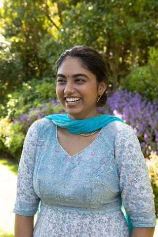 Elegant Woman Enjoying Sunny Day in Vibrant Garden