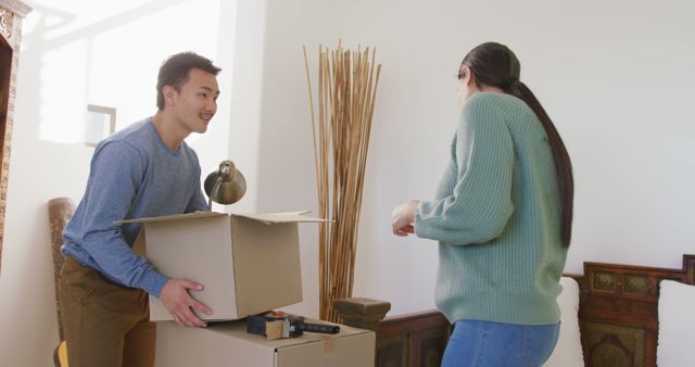 Image of happy diverse couple unpacking boxes after moving in - Download Free Stock Photos Pikwizard.com