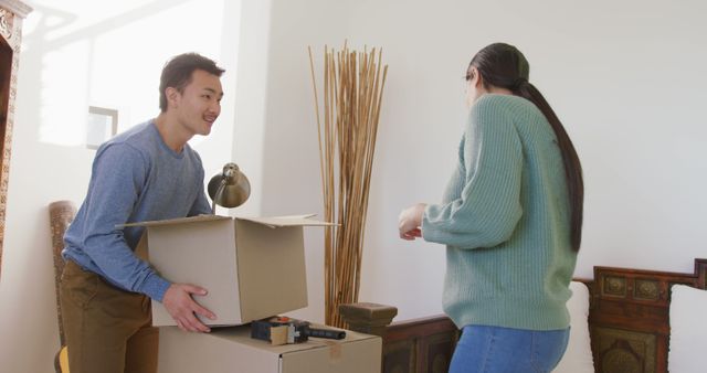 Couple Moving into New Home With Boxes in Living Room - Download Free Stock Images Pikwizard.com