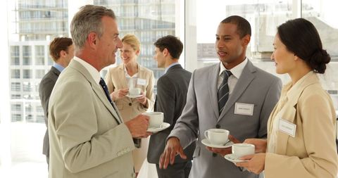 Business Professionals Networking with Coffee at Conference