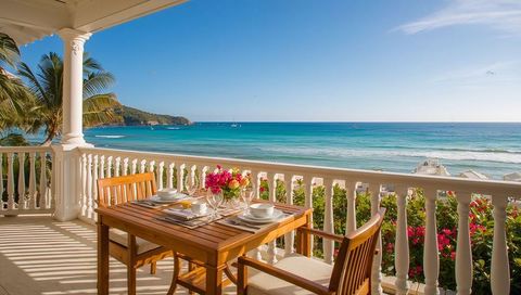 Sunlit Tropical Oceanfront Balcony Dining for Two with Wooden Table and Ocean View
