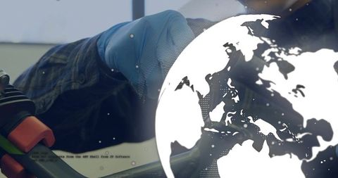 Technician repairing industrial equipment wearing blue glove and shirt with globe overlay