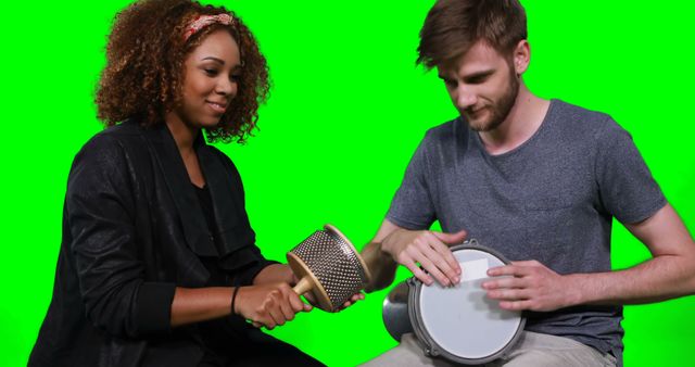 Happy musicians playing cabasa and drum against green screen - Download Free Stock Photos Pikwizard.com