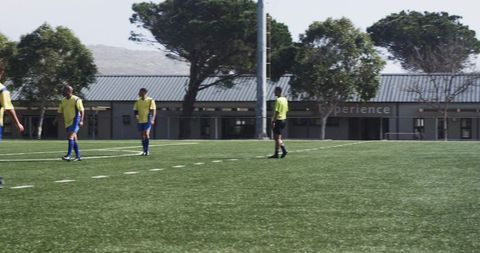 Soccer Players Practice on Field Focusing on Strategy Outdoors