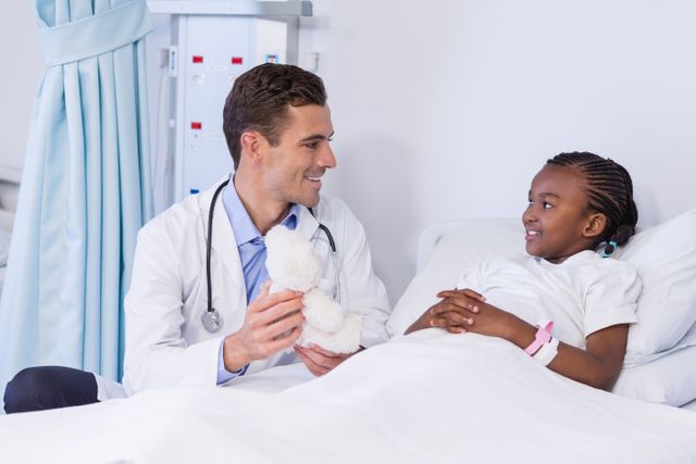 Doctor comforting young patient in hospital bed, ideal for healthcare, pediatric care, and medical professional themes. Useful for illustrating patient care, doctor-patient interaction, and hospital environments. Can be used in medical articles, healthcare brochures, and pediatric care promotions.