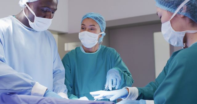 Image of diverse male and female surgeons talking during operation in theatre - Download Free Stock Photos Pikwizard.com