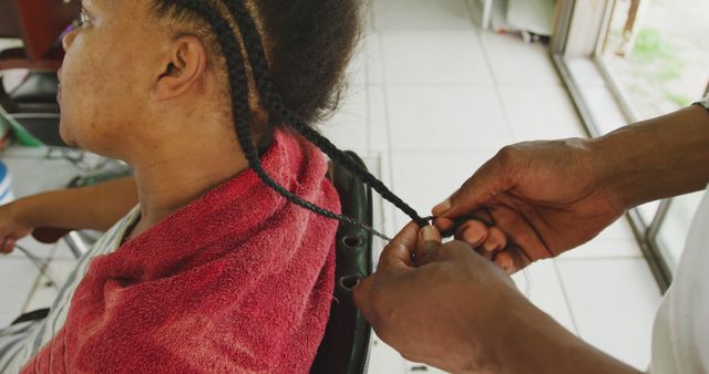 Hairdresser braiding braid for African American woman in salon - Download Free Stock Images Pikwizard.com