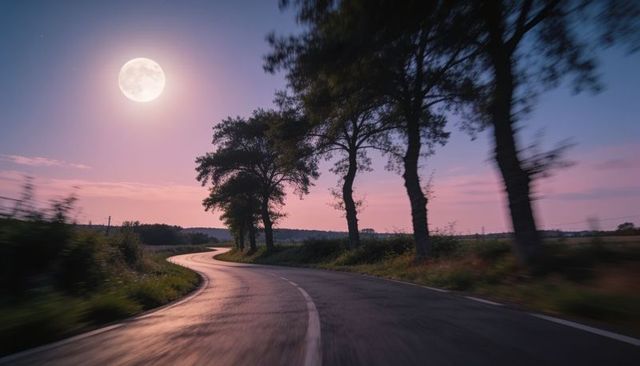 Winding moonlit country road reflecting twilight glow along tree-lined wet curved asphalt