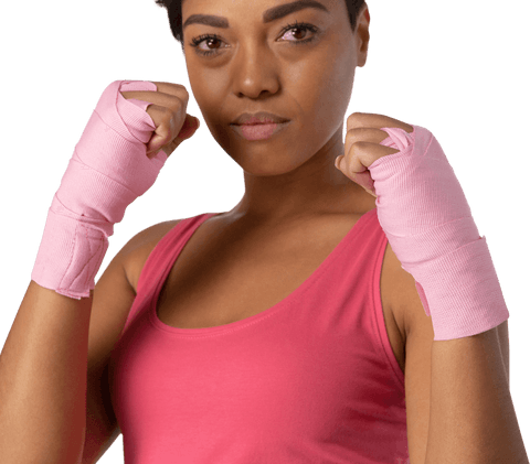 Confident woman showing strength with pink wrist wraps on transparent background