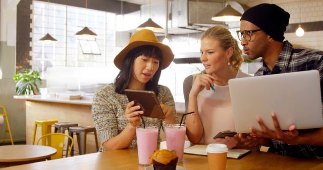 Group of Young Adults Discussing Work Over Coffee in Modern Cafe - Download Free Stock Images Pikwizard.com