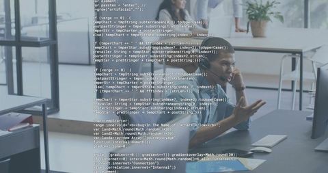 Developer Gesturing While Explaining Code on Monitor in Open Office with Team Collaboration