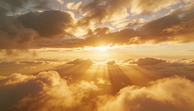 Golden crepuscular rays over cloudscape casting warm sunbeams near horizon