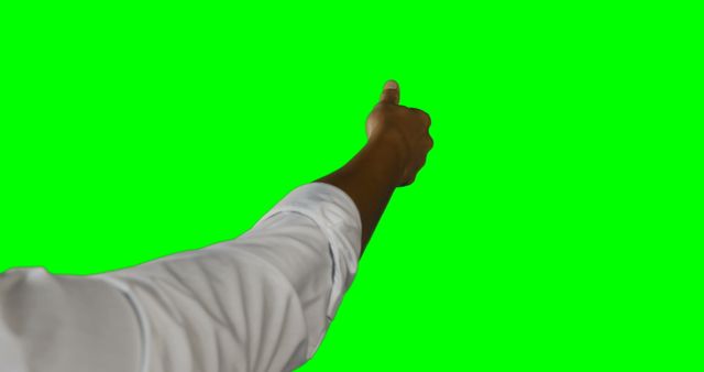 Close-up of a hand pointing forward on a green screen background. Useful for creating digital content, presentations, virtual reality projects, or as an overlay in videos. Can also be used in advertisements and social media posts to emphasize a call-to-action or guide viewer's attention.