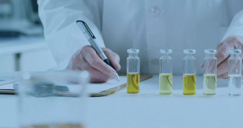 Scientist with vials conducting laboratory research