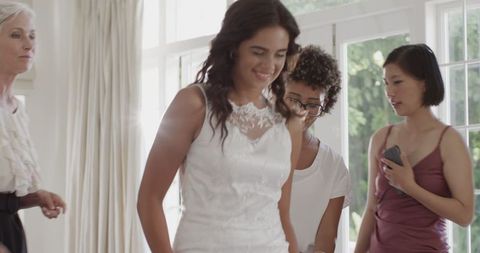 Bride Adjusting Leg Garter Preparing for Wedding Ceremony Indoors