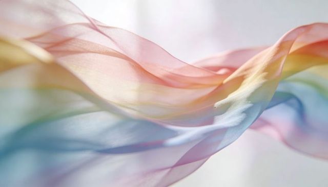 Flowing pastel silk chiffon ribbon creating ethereal translucent gradient waves