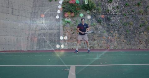 Mature male tennis player preparing swing on outdoor court