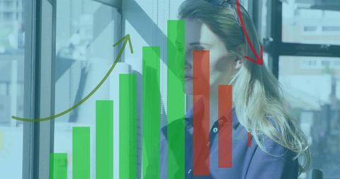 Caucasian Woman with Financial Graphs Against Office Window