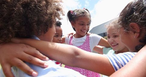 Happy Diverse Kids Hugging and Enjoying Outdoor Fun