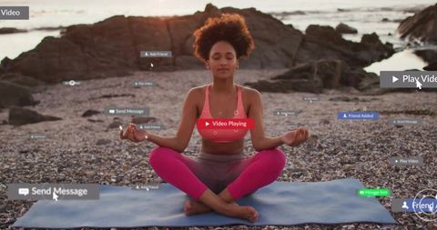 Woman Meditating on Beach Surrounded by Digital Interaction Icons