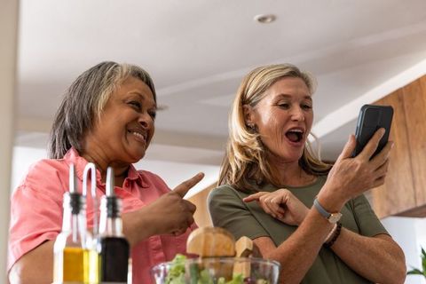 Senior female friends enjoying smartphone classes at home
