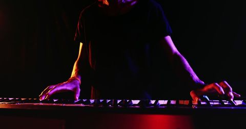Keyboard Player Energizing a Live Performance with Colored Stage Lights - Download Free Stock Images Pikwizard.com
