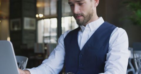 Confident Businessman Working at Cafe with Laptop Focus