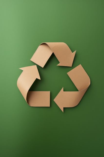 Paper arrows recycling sign on green background, created using generative ai technology. Recycling, environment and climate change awareness concept digitally generated image.