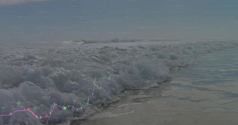 Ocean waves washing over wet sand with candlestick trading chart overlay for finance