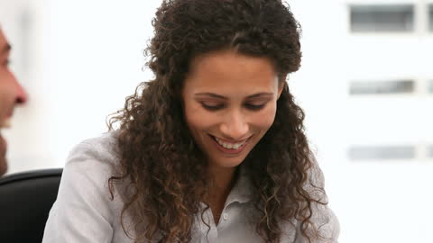 Smiling Businesswoman in Relaxed Office Meeting Scene