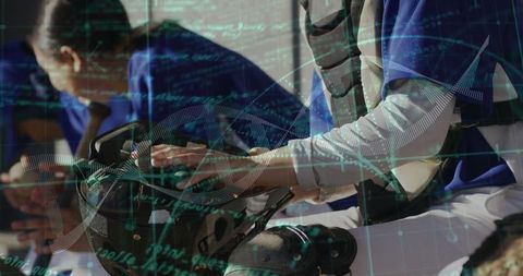 Catcher adjusts gear in dugout with technology overlay