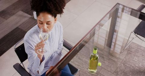 Woman Savoring White Wine at Office Desk During Break - Download Free Stock Images Pikwizard.com