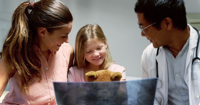 Family visiting friendly doctor during medical consultation. Child holding teddy bear, family interactions, warm atmosphere, pediatric care, health check-up, trust in healthcare providers. Perfect for medical, family care, pediatric healthcare promotions.