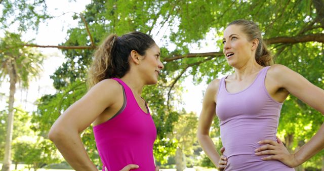 Two Women in Sportswear Talking in Park During Workout - Download Free Stock Images Pikwizard.com