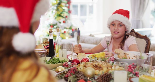 Young Girl Wearing Santa Hat at Festive Christmas Dinner Table - Download Free Stock Images Pikwizard.com